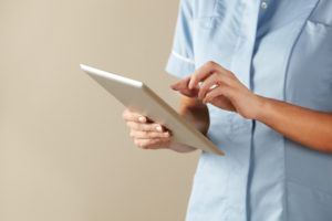A picture of a nurse with a tablet